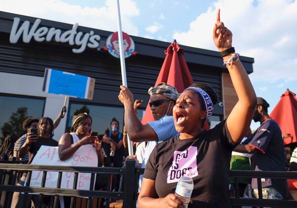 Protesters gather on Saturday evening at the Atlanta Wendy's where Rayshard Brooks, a 27-year-old black man,  was shot and killed by Atlanta police the night before during a struggle in the drive-thru line.    Ben Gray for the Atlanta Journal Constitution