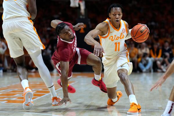 Tennessee guard Jordan Gainey (11) moves past Alabama forward Mouhamed Dioubate in the first half of an NCAA college basketball game Saturday, March 1, 2025, in Knoxville, Tenn. (AP Photo/Mark Humphrey)