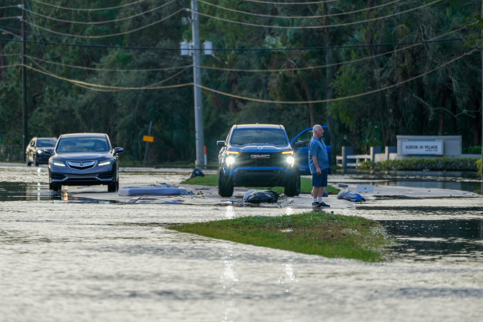 A man negotiates driving through flood waters into a community surrounded with floodwaters the morning after Hurricane Milton hit the region, Thursday, Oct. 10, 2024, in Tampa, Fla. (AP Photo/Julio Cortez)