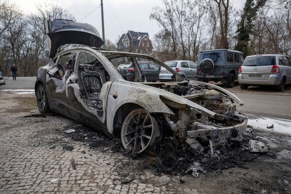 A burnt-out Tesla car stands in the Steglitz district of Berlin, Friday, March 14, 2025, as four Teslas are suspected to have been set on fire in Berlin last night. (Christophe Gateau/dpa via AP)