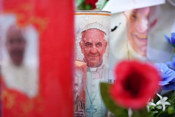 Candles and flowers for Pope Francis are seen at the Agostino Gemelli Polyclinic, in Rome, Tuesday, Feb. 25, 2025 where Pope Francis is hospitalized since Friday, Feb. 14.(AP Photo/Alessandra Tarantino)