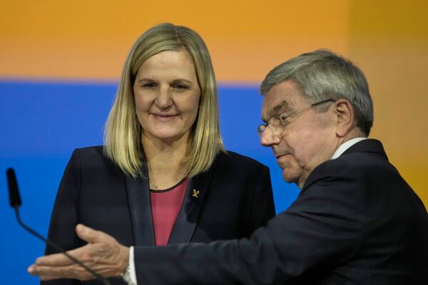 IOC President Thomas Bach, right, gestures to Kirsty Coventry after she was announced as the new IOC President at the International Olympic Committee 144th session in Costa Navarino, western Greece, Thursday, March 20, 2025. (AP Photo/Thanassis Stavrakis)