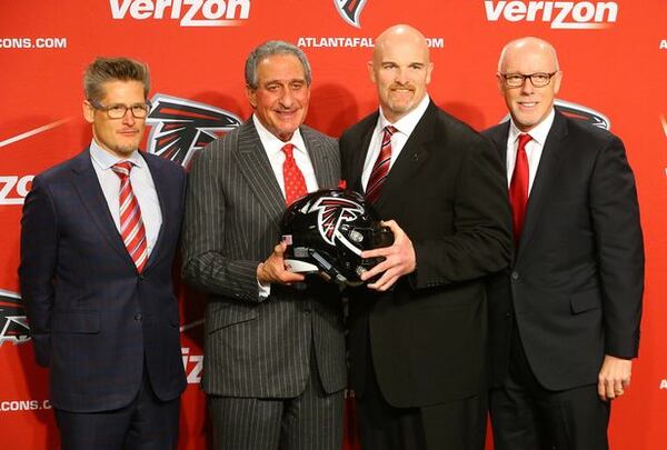 General manager Thomas Dimitroff (from left), owner Arthur Blank, coach Dan Quinn and President and CEO Rich McKay pose for a photo at the end of a news conference introducing Quinn as coach on Feb. 3 in Flowery Branch. Curtis Compton / ccompton@ajc.com