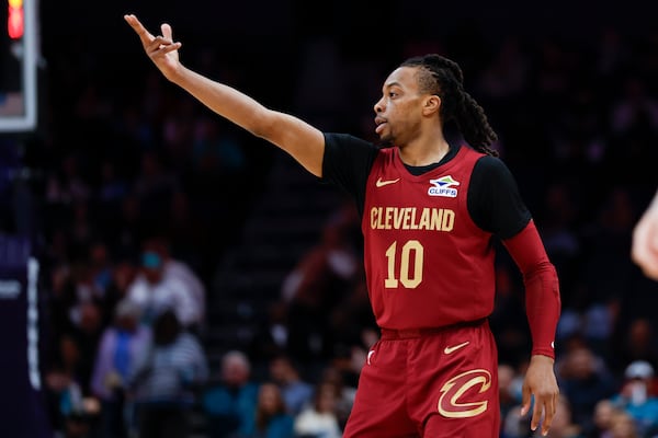 Cleveland Cavaliers guard Darius Garland gestures after scoring against the Charlotte Hornets during the first half of an NBA basketball game in Charlotte, N.C., Friday, March 7, 2025. (AP Photo/Nell Redmond)