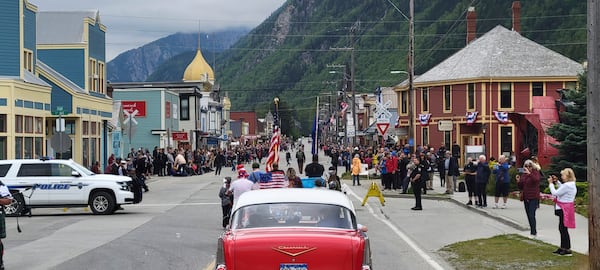 People gather along the streets of Skagway, Alaska, for a Fourth of July parade Tuesday, July 4, 2023. (Andrew Cremata via AP)