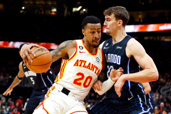 Atlanta Hawks forward John Collins (20) drives to the basket as Orlando Magic forward Franz Wagner (22) defends during the first half of an NBA basketball game Friday, Oct. 21, 2022, in Atlanta. (AP Photo/Butch Dill)