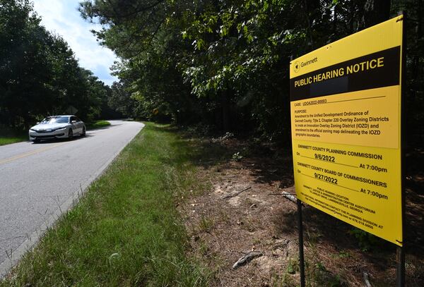 August 30, 2022 Dacula - Public Hearing Notice for rezoning is posted along Drowning Creek Road in Dacula  near future site of Rowen development, a "knowledge community" similar to the research triangle that is scheduled to break ground in October, on Tuesday, August 30, 2022. University Pkwy (US-29) is shown on left. (Hyosub Shin / Hyosub.Shin@ajc.com)