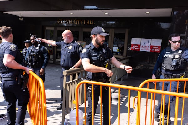 Atlanta police officers set barricades in front of City Hall as council members are expected to vote on legislation that funds construction of the planned training center in DeKalb County on June 5, 2023. (Arvin Temkar/arvin.temkar@ajc.com)