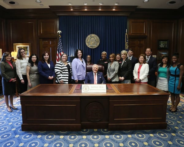 Members of the Georgia Women’s Policy Institute and other advocates stand with Rep. Mandi Ballinger and Gov. Nathan Deal at the bill signing ceremony for HB 834. CONTRIBUTED