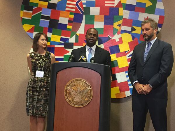 Mayor Kasim Reed (center) speaks about Atlanta’s participation in Rockefeller Foundation’s 100 Resilient Cities on Monday. He is flanked by Stephanie Stuckey Benfield, director of sustainability for the city of Atlanta (left) and Michael Berkowitz, president of 100 Resilient Cities. (Leon Stafford/lstafford@ajc.com)