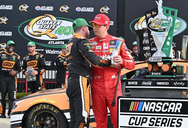 Kyle Busch (right, red) congratulates his brother, Kurt Busch, (left) on winning the Quaker State 400 Presented by Walmart Sunday, July 11, 2021, at Atlanta Motor Speedway in Hampton. Busch passed brother Kyle with 24 laps left and won the NASCAR Cup Series race Sunday to complete a sibling weekend Atlanta sweep. (Hyosub Shin / Hyosub.Shin@ajc.com)