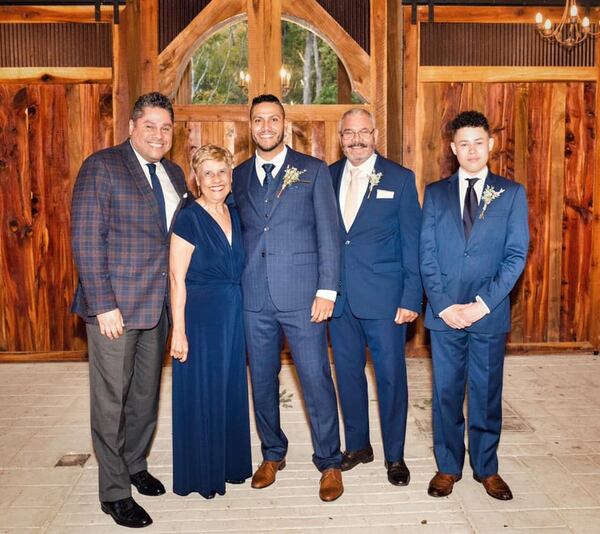 Joel Alvarado (left), at his brother’s wedding, along with his mother, Carmen Alvarado, brother Christian Alvarado, father Joel Alvarado and son Nation Shabazz Alvarado. COURTESY JOEL ALVARADO