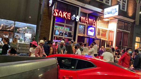 Partygoers, many of them University of Georgia students, wait to get inside one of several bars in Athens near the campus Sept. 19, 2020. Some patrons wore face coverings. Others did not. (Eric Stirgus / Eric.Stirgus@ajc.com)