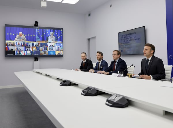 French President Emmanuel Macron, right, holds a video meeting gathering European Union (EU) 27 leaders following his meeting with US President Donald Trump, at the Elysee palace in Paris, Wednesday, Feb. 26, 2025. (Ludovic Marin, Pool via AP)