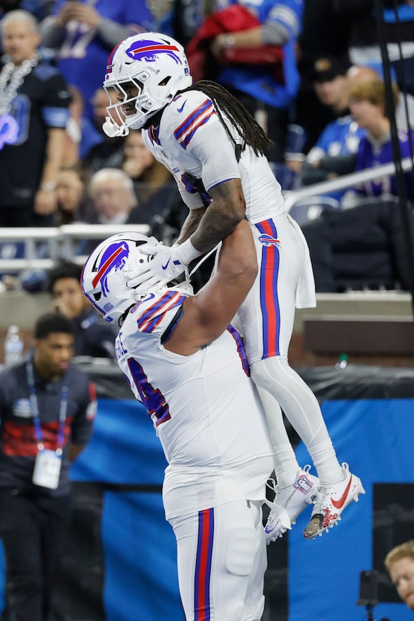 Buffalo Bills running back James Cook, top, is congratulated by guard O'Cyrus Torrence after scoring against the Detroit Lions during the second half of an NFL football game, Sunday, Dec. 15, 2024, in Detroit. (AP Photo/Duane Burleson)