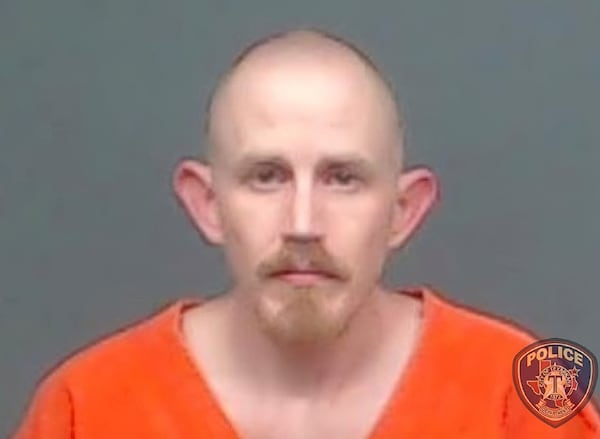 In this file image provided by the Texarkana, Texas, Police Department, Aaron Swenson is seen in his police booking photo. The Arkansas man, whose Facebook page included "boogaloo" references, was arrested on April 11 by police in Texarkana, Texas, on a charge he threatened to ambush and kill a police officer on a Facebook Live video. He was indicted June 11 on charges including attempt to commit capital murder of a peace officer.