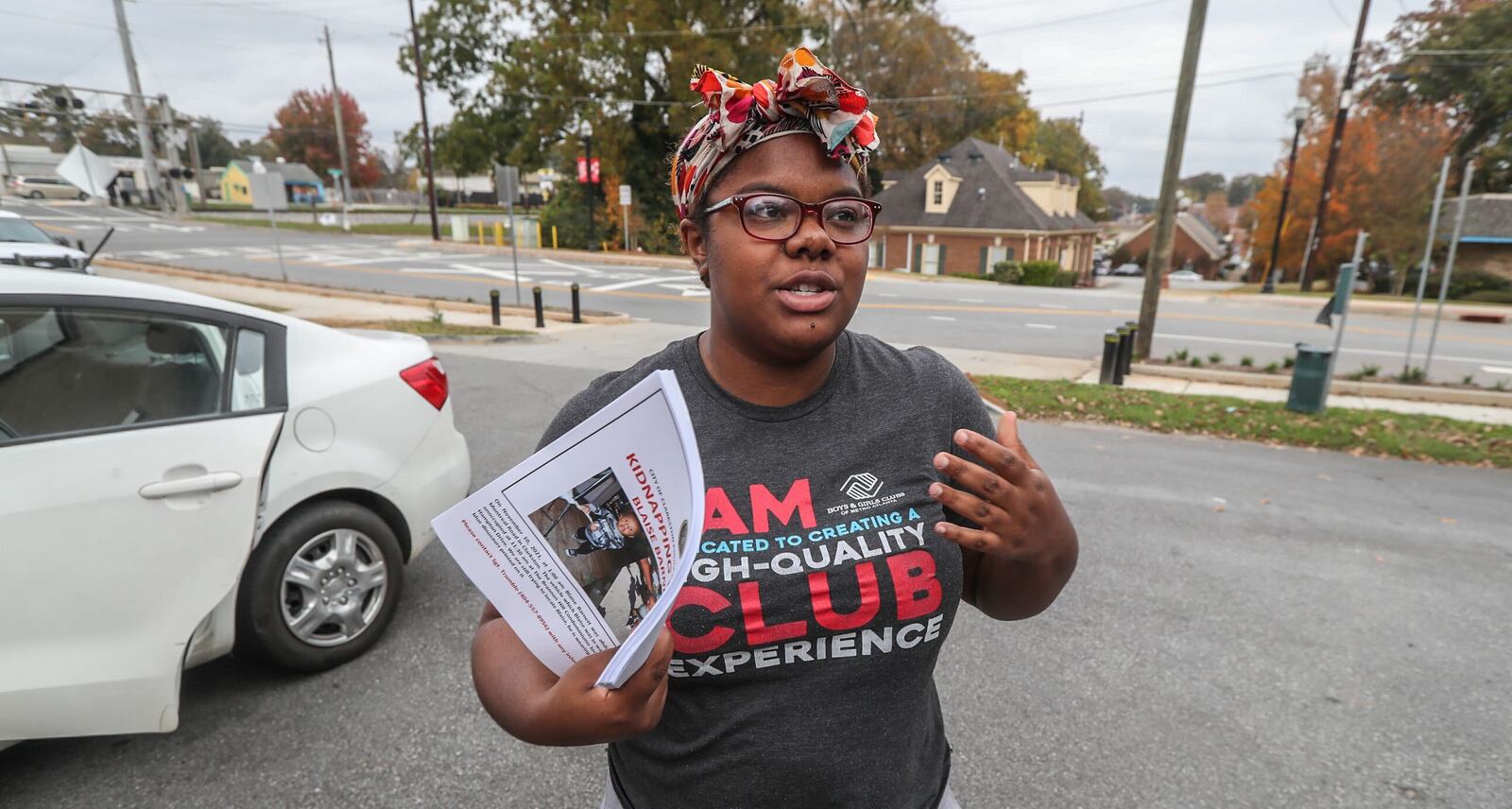 Deonna Bray stands outside the Clarkston Police Department on Thursday morning with a stack of missing person flyers. The mother has not seen her 1-year-old son, Blaise Barnett, since 1 a.m. Wednesday, when he was taken along with the family's SUV from their Clarkston apartment.