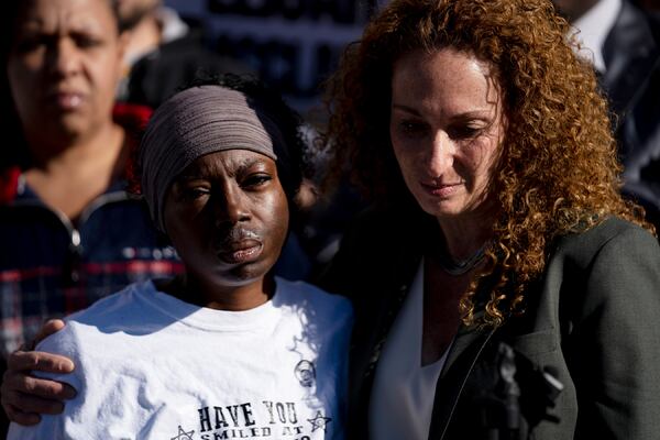 File-In this Nov. 23, 2019, file photo, attorney, Mari Newman, right, hugs Sheneen McClain during a press conference at the Aurora Municipal Center after the police department released the body camera footage of McClain's son, Elijah, being stopped while walking by three officers from the Aurora Police in late August 2019. McClain died three days later from injuries sustained during the stop. (Philip B. Poston/Sentinel Colorado via AP, File)