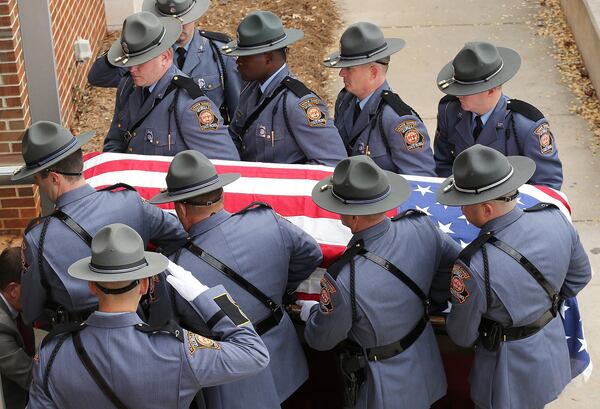 The North Carolina Troopers Association/N.C. Highway Patrol Caisson Unit carries Officer Nicholas Smarr’s coffin at his funeral on Sunday, Dec. 11, 2016. (Photo: Curtis Compton/ccompton@ajc.com)