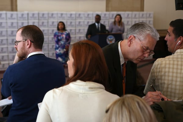 The Channel 2 Action News team jots down notes following a question posed to Mayor Kasim Reed at City Hall in Atlanta during a press conference before the release of 1.4 million documents pertaining to the City Hall bribery case on Thursday, February 9, 2017. (HENRY TAYLOR / HENRY.TAYLOR@AJC.COM)