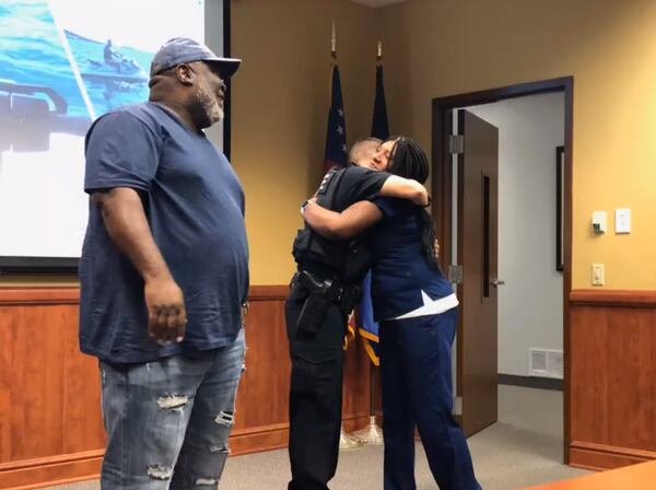 Regina Beard hugs Marietta officer Matthew Salyers, who saved her life while she was vacationing in Destin, Florida, over the Memorial Day weekend.