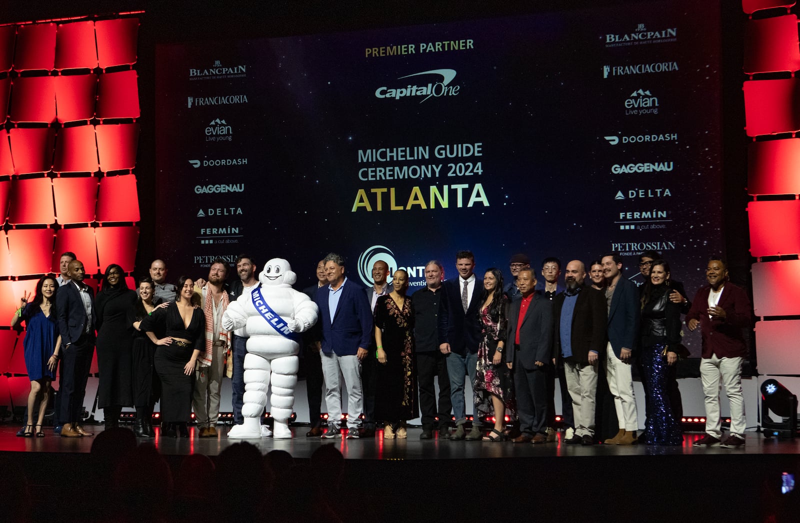 Restaurateurs whose establishments earned a Bib Gourmand designation, which recognizes great food at a great value, gather on the stage at the Georgia World Congress Center during the 2024 Atlanta Michelin Guide ceremony. (Jenni Girtman for the AJC)