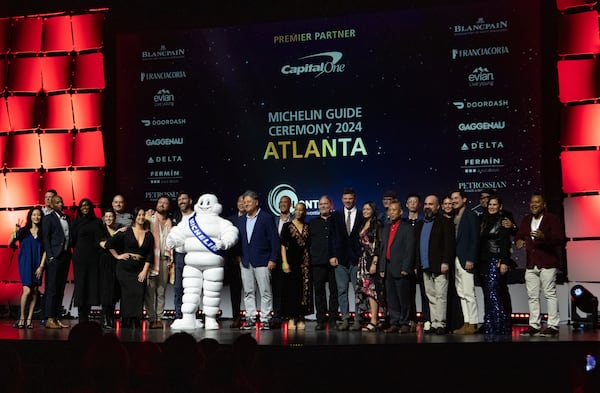 Restaurateurs whose establishments earned a Bib Gourmand designation, which recognizes great food at a great value, gather on the stage at the Georgia World Congress Center during the 2024 Atlanta Michelin Guide ceremony. (Jenni Girtman for the AJC)