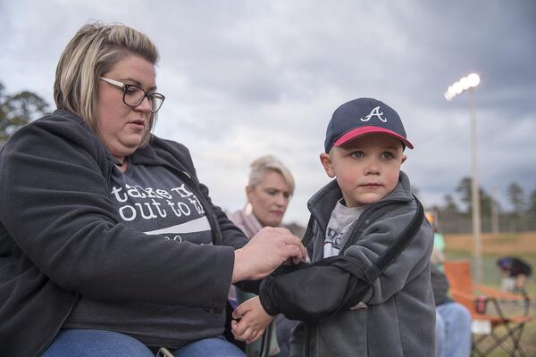 Cami Abernathy readjusts the sling on her son Carter’s arm at Manning Mill Park in Adairsville. Carter recently had surgery to assist with his suspected acute flaccid myelitis, a neurological condition that can cause a polio-like illness. ALYSSA POINTER / ALYSSA.POINTER@AJC.COM