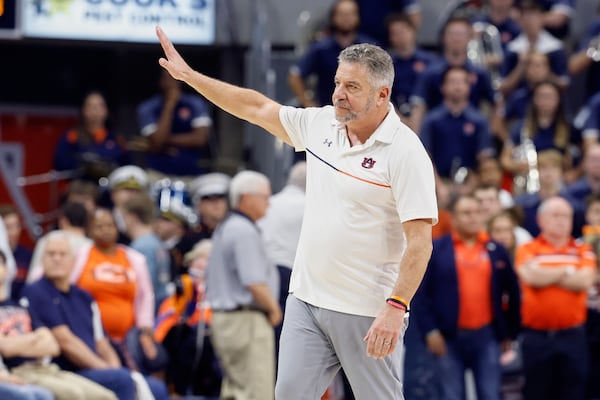 Auburn head coach Bruce Pearl urges fans to stop throwing things onto the court after a loss to Alabama in an NCAA college basketball game, Saturday, March 8, 2025, in Auburn, Ala. (AP Photo/Butch Dill)