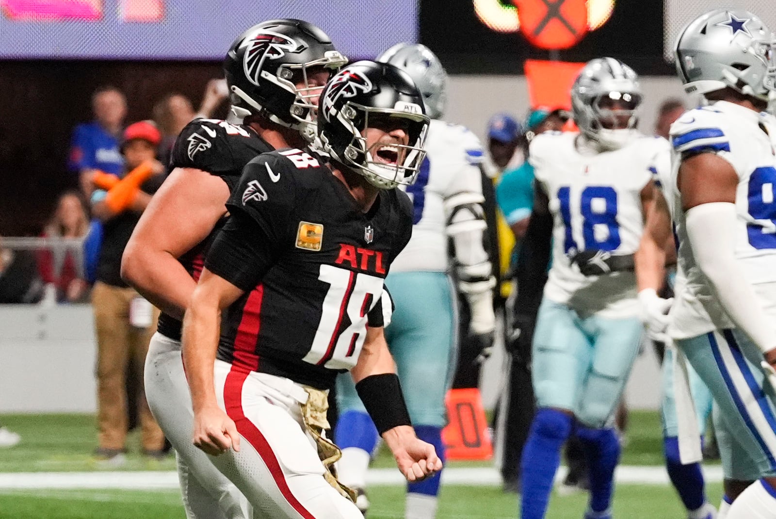 Atlanta Falcons quarterback Kirk Cousins (18) celebrates after a touchdown during the second half of an NFL football game against the Dallas Cowboys, Sunday, Nov. 3, 2024, in Atlanta. (AP Photo/ John Bazemore)