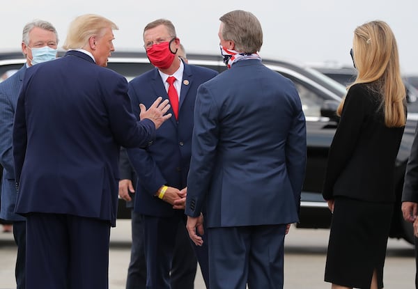 U.S. Rep.  Rick Allen, from left, President Donald Trump, U.S. Rep. Doug Collins, and U.S. Sens. David Perdue and Kelly Loeffler greet each other at Hartsfield-Jackson International Airport in July 2020. Collins and Loeffler ran against each other that year, but Democrat Raphael Warnock won the Senate seat in a 2021 runoff. Curtis Compton ccompton@ajc.com