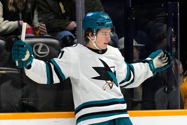 FILE- San Jose Sharks center Macklin Celebrini celebrates after scoring a goal against the Nashville Predators during the first period of an NHL hockey game, Tuesday, Jan. 21, 2025, in Nashville, Tenn. (AP Photo/Mark Humphrey, File)