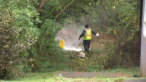 Workers respond to a sewer spill in DeKalb County.