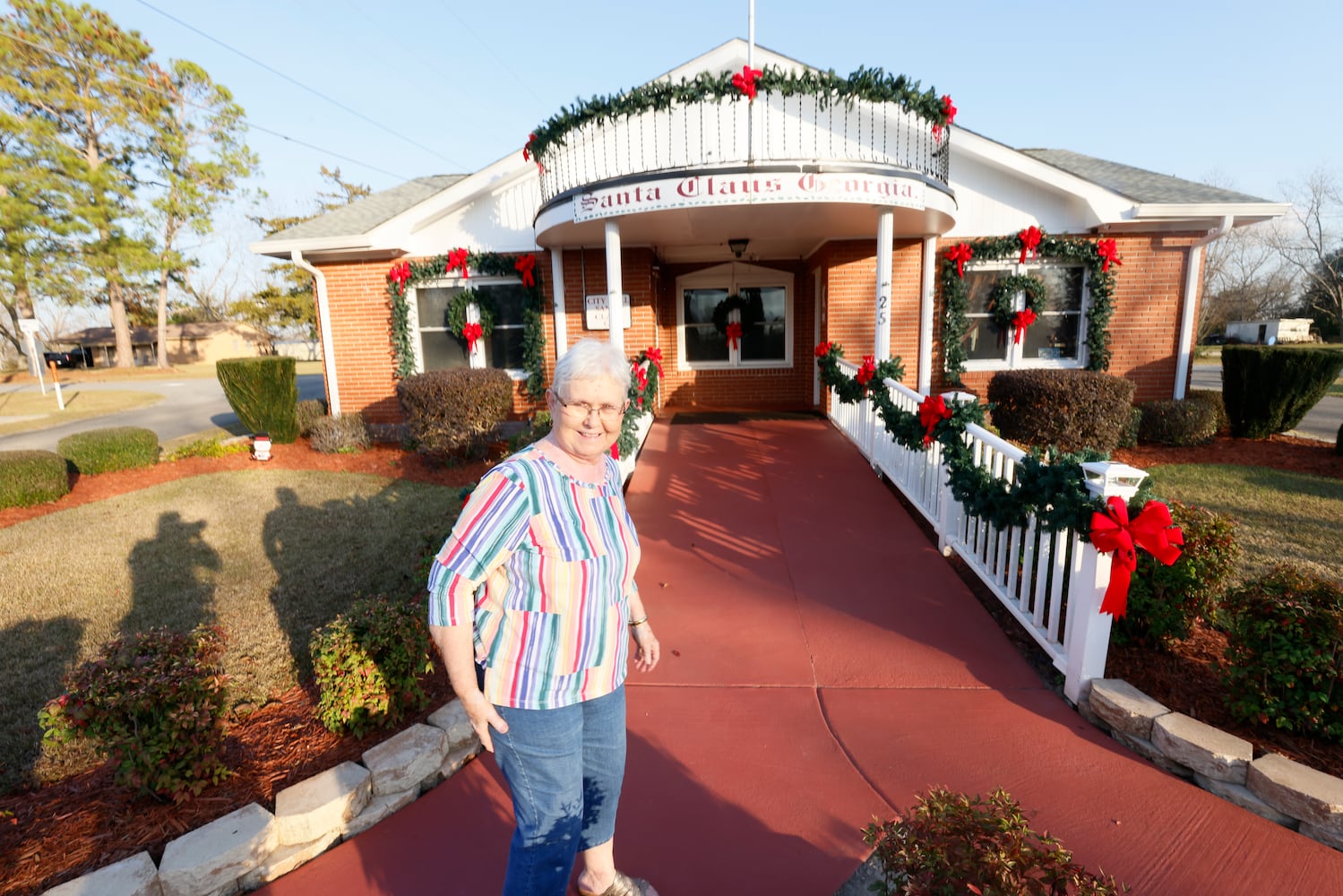 One of the tasks during the holiday season from Sue Grisham, Santa Claus city's secretary, is to collect many Christmas letters from the mailbox ready to be stamped; the amount increases in the weeks leading up to the holiday: it is a hand stamp with the city logo.
 Miguel Martinez / miguel.martinezjimenez@ajc.com