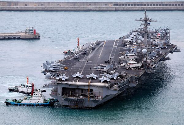 The USS Carl Vinson aircraft carrier is escorted into a navy port in Busan, South Korea, Sunday, March 2, 2025. (Son Hyung-ju/Yonhap via AP)