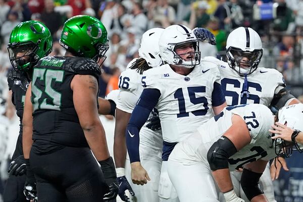 Penn State quarterback Drew Allar (15) celebrates after a 7-yard touchdown run during the first half of the Big Ten championship NCAA college football game against Oregon, Saturday, Dec. 7, 2024, in Indianapolis. (AP Photo/Darron Cummings)