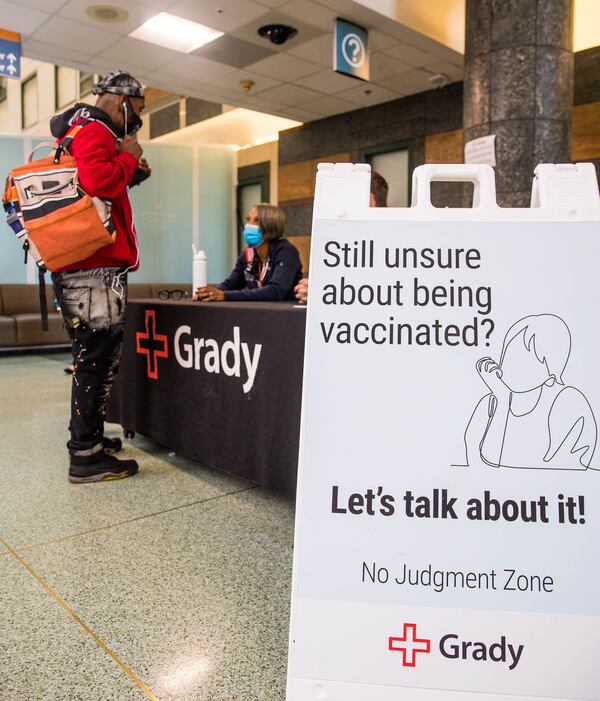 Dr. Manning, seated at right, says, “What we pitched to Grady is, what if we just set up a table in the middle of Grady in the lobby that says, ‘We’ll answer your question. And we’re not going to judge you and we’re not going to label you as anything.’ You’re just a person who has a question. And we are able to give you factual information.” (Jenni Girtman for The Atlanta Journal-Constitution)