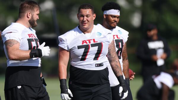 Falcons offensive lineman from left to right; Jonotthan Harrison (62), Justin Shaffer (75), Colby Gossett (66), Jalen Mayfield (77) and  Elijah Wilkinson (68) walk to the next drill during Falcons training camp Thursday, July 28, 2022, in Flowery Branch, Ga. (Jason Getz / Jason.Getz@ajc.com)