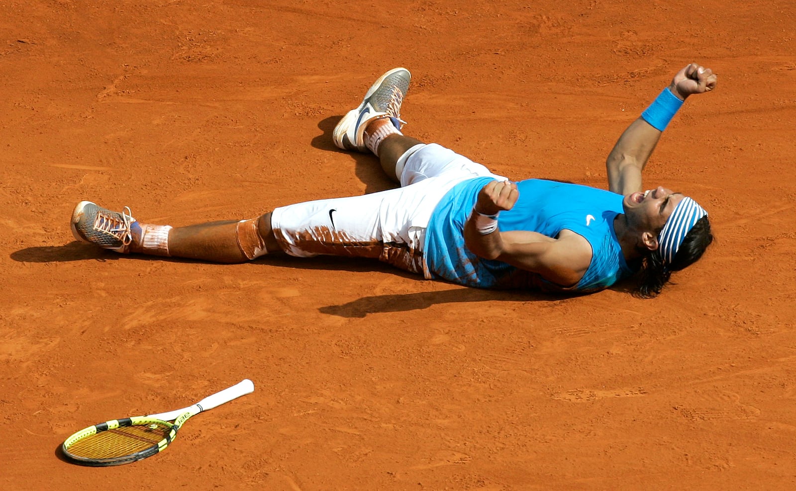 FILE - Rafael Nadal of Spain reacts after defeating Roger Federer of Switzerland during the final of the Monte Carlo Tennis Open tournament in Monaco, Sunday, April 27, 2008, as he has announced he will retire from tennis at age 38 following the Davis Cup finals in November. (AP Photo/Lionel Cironneau, File)