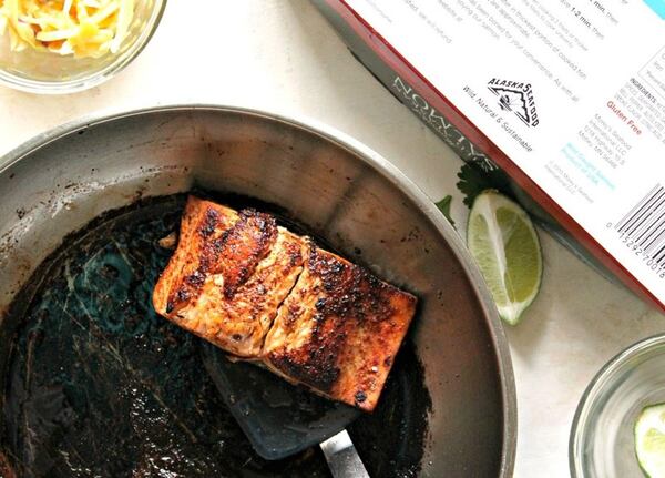 Salmon fillets get a kick from blackened seasoning. After a pan searing, the fish is finished in the oven.  