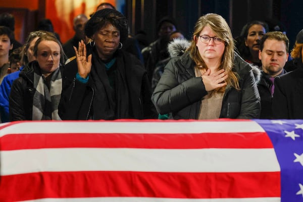 Visitors gather to honor Jimmy Carter as he lies in repose at the Jimmy Carter Presidential Library in Atlanta on Monday. Carter remained at the center until Tuesday at 6 a.m., when his remains were transported to Washington, D.C. Miguel Martinez/AJC