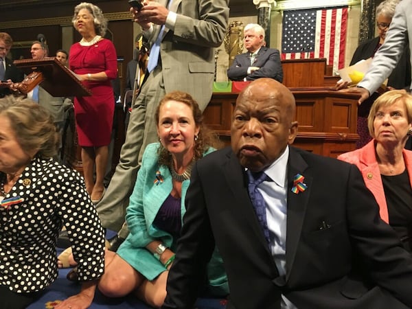 This photo provided by Rep. Chillie Pingree, D-Maine, shows Democrat members of Congress, including Rep. John Lewis, D-Ga., center, and Rep. Elizabeth Esty, D-Conn. as they participate in sit-down protest seeking a a vote on gun control measures, Wednesday, June 22, 2016, on the floor of the House on Capitol Hill in Washington. (Rep. Chillie Pingree via AP)