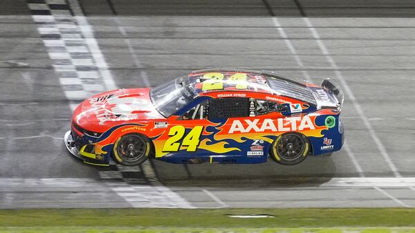 William Byron (24) crosses the finish line to win the NASCAR Daytona 500 auto race at Daytona International Speedway, Sunday, Feb. 16, 2025, in Daytona Beach, Fla. (AP Photo/John Raoux)