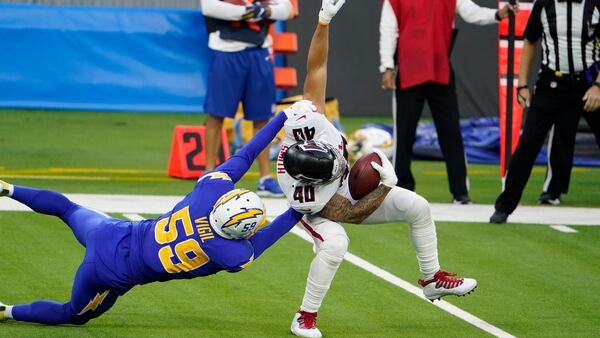 Falcons fullback Keith Smith (40) is tackle by Los Angeles Chargers outside linebacker Nick Vigil (59) during the second Sunday, Dec. 13, 2020, in Inglewood, Calif. (Jae C. Hong/AP)