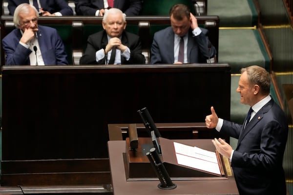 Polish Prime Minister Donald Tusk, right, speaks at the Sejm, the lower house of parliament, in Warsaw, Poland, Friday March 7, 2025. (AP Photo/Czarek Sokolowski)