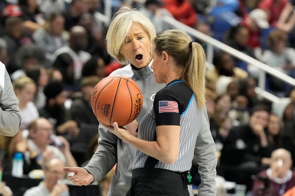 Georgia Tech head coach Nell Fortner, back, argues a call with an official during an NCAA college basketball game against North Carolina State in the quarterfinals of the Atlantic Coast Conference tournament Greensboro, N.C., Friday, March 7, 2025. (AP Photo/Chuck Burton)