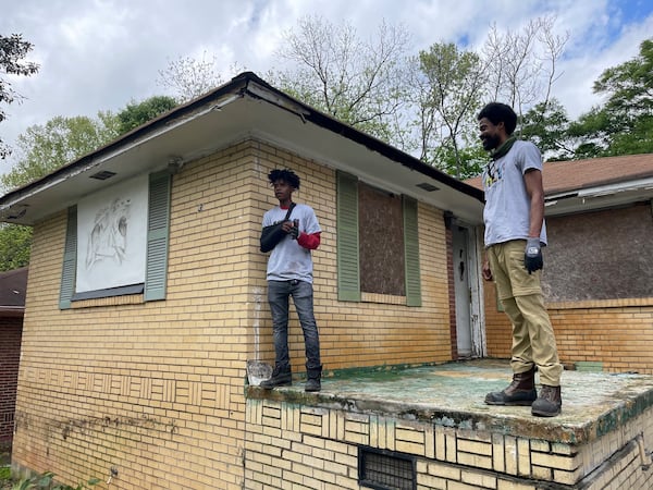 Marc KD Boyd, right, the co-founder of HEY!, and A.B Roberts admire the work done at the former home of Kathryn Johnston, who was killed by police in 2006. Photo by Bill Torpy