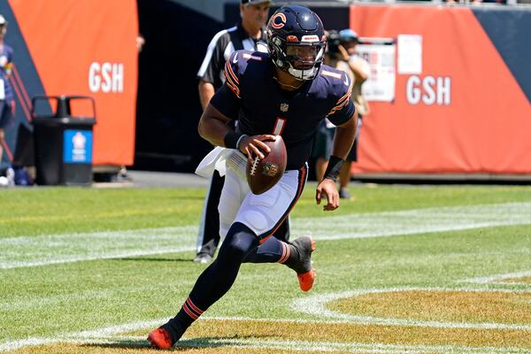 Chicago Bears quarterback Justin Fields runs with the ball during the first half of an NFL preseason football game against the Miami Dolphins in Chicago, Saturday, Aug. 14, 2021. (AP Photo/Nam Y. Huh)