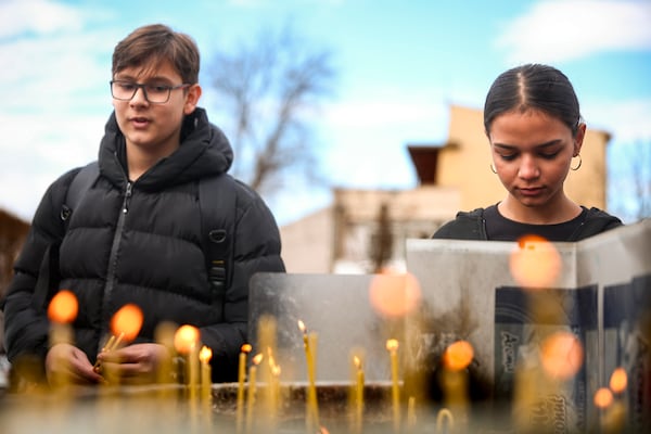 Youngsters light candles for the victims of a massive nightclub fire early Sunday in the town of Kocani, North Macedonia, Monday, March 17, 2025, (AP Photo/Armin Durgut)