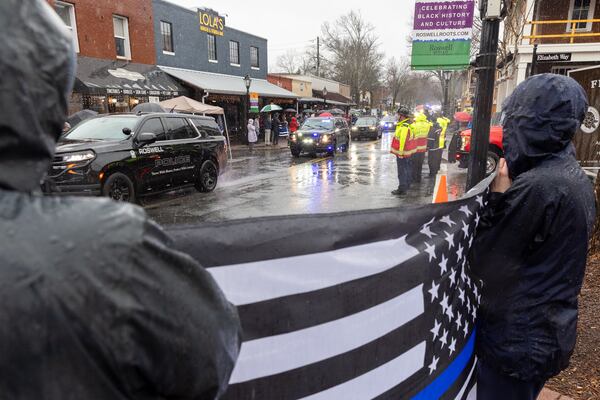 A funeral procession for fallen police officer Jeremy Labonte drives through downtown Roswell on Wednesday, February 12, 2025. The 24-year-old Roswell Police Department officer was shot to death on Friday evening. (Arvin Temkar / AJC)